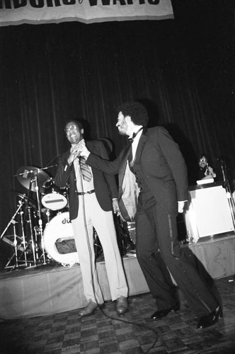 James Ingram joking with Bill Cosby during a Neighbors of Watts benefit performance, Los Angeles, 1982