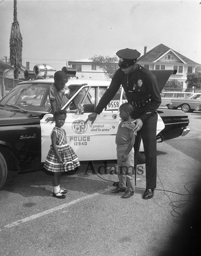 Policeman and children, Los Angeles, 1965