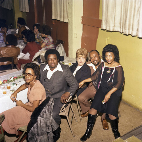 Connie Thompson posing with guests at a Super Bowl party, Los Angeles, 1977