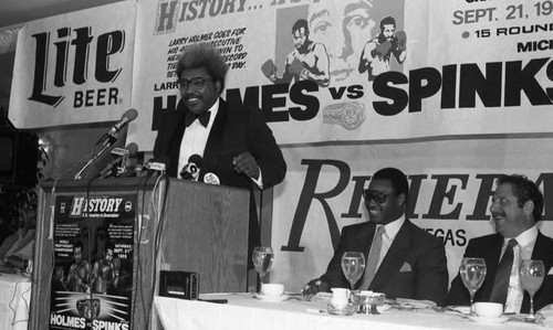 Don King speaking at a Holmes vs. Spinks match press conference, 1985