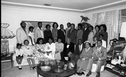 Frankie and Doug Bell posing with party guests, Los Angeles, 1986