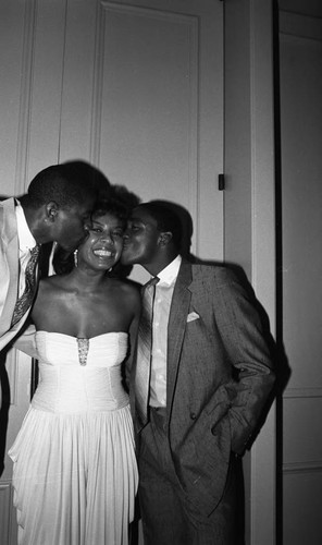 Magic Johnson posing with Isiah Thomas and a young woman at Johnson's birthday party, Los Angeles, 1986