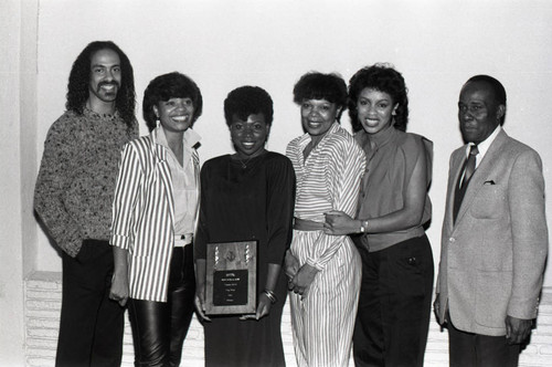 Singing group Krystol and Leon Sylvers posing with an award at the Pied Piper Nightclub, Los Angeles, 1984