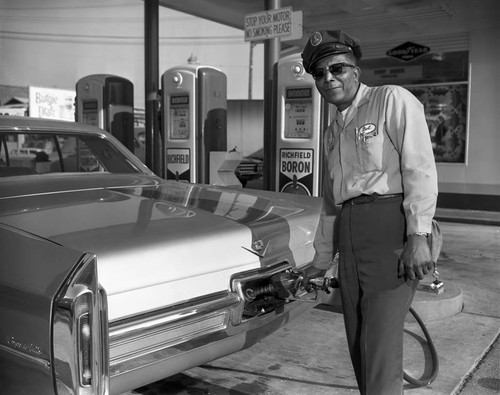 Service attendant fuels car, Los Angeles, 1966