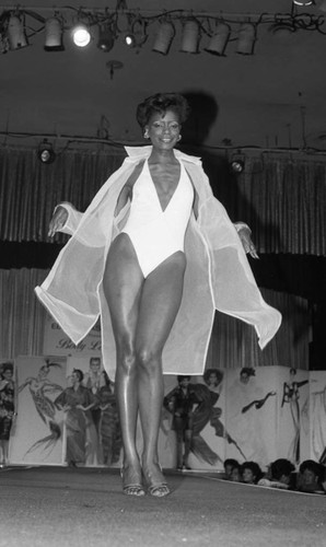 Ebony Fashion Fair model posing on a catwalk, Los Angeles, 1986