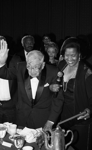 Dr. H. Claude Hudson standing with Myrlie Evers at the NAACP awards dinner, Los Angeles, 1986