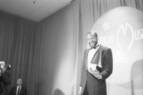 Marvin Gaye posing with his American Music Award, Los Angeles, 1983