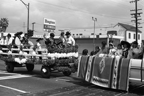 Cinco de Mayo parade float passes along a Compton street, Los Angeles, 1973