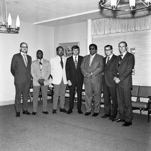 Men posing together in a meeting room at Compton College, 1972