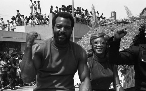 Watts Summer Festival participant Jim Brown riding in a parade, Los Angeles, ca. 1973