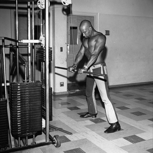 Man exercising at the Compton College gym, Compton, 1972