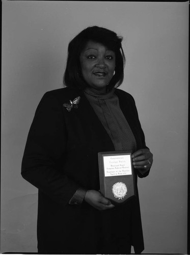 Carolyn Smith holding an award from the Compton Municipal Court, Los Angeles, 1991