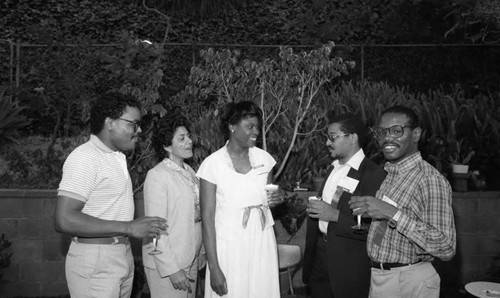 Guests talking during an event at the home of Dr. James Crayton, Los Angeles, 1983