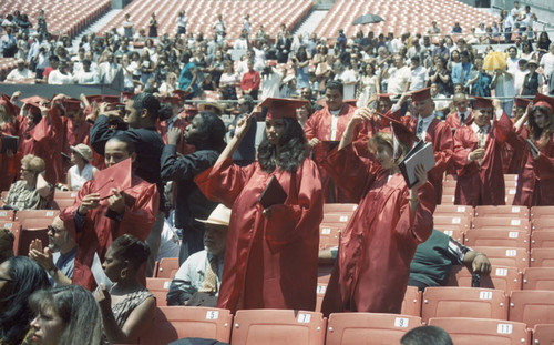 Nicole Bailey standing during her graduation ceremony, Los Angeles, 1996