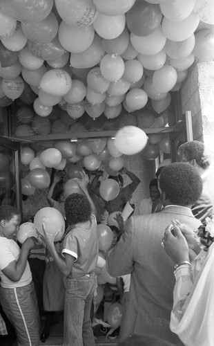 28th Street Y.M.C.A. grand opening participants enjoying balloons, Los Angeles, 1984