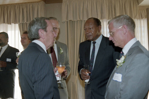 Warren Christopher and Tom Bradley talking with others, Los Angeles, 1992