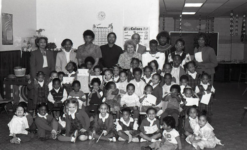 Children and their teachers posing for a group portrait, Los Angeles, 1987