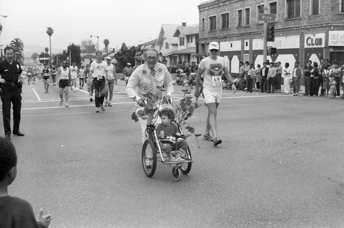 Man pushing a stroller in the first LA Marathon, Los Angeles, 1986