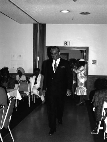 Man walking among tables during a Los Angeles Urban League event, Los Angeles, 1993