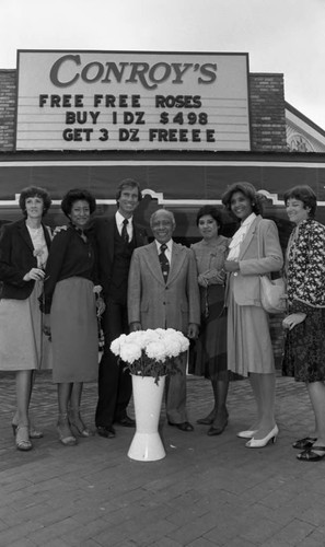 Gilbert Lindsay posing with others at the opening of a Conroy's Flowers fancise, Los Angeles, 1982