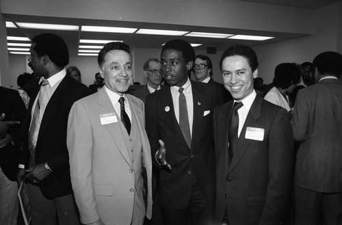 Elbert T. Hudson and Paul C. Hudson talking with an unidentified man, Los Angeles, 1984