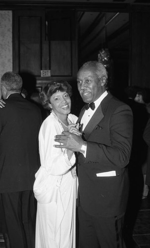 Charlotte Mead and Nate Holden dancing together during the Delta Sigma Theta Red and White Ball, Los Angeles, 1987