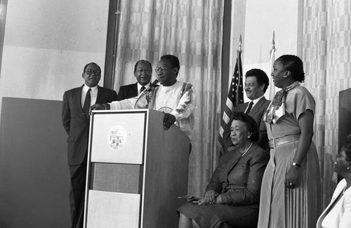 Black Family Reunion press conference participants listening to Bill Cosby, Los Angeles, 1987