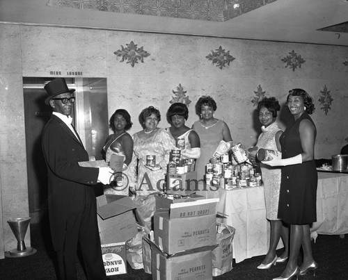 Women and man with canned food, Los Angeles, 1969