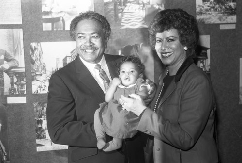 Mervyn Dymally holding a baby, Los Angeles, 1984