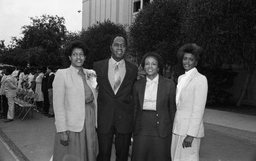 Myrlie Evers-Williams posing outdoors with others at an event, Los Angeles, 1982