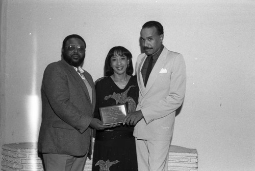 Phillip Fenty posing with Reve Gipson and an award at the Pied Piper nightclub, Los Angeles, 1986