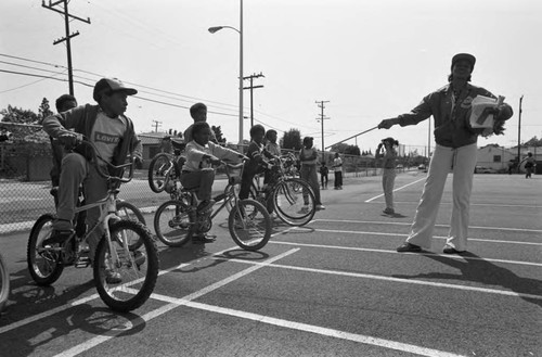 Boys preparing to ride bicycles at Beulah Payne Elementary School, Inglewood, California, 1983