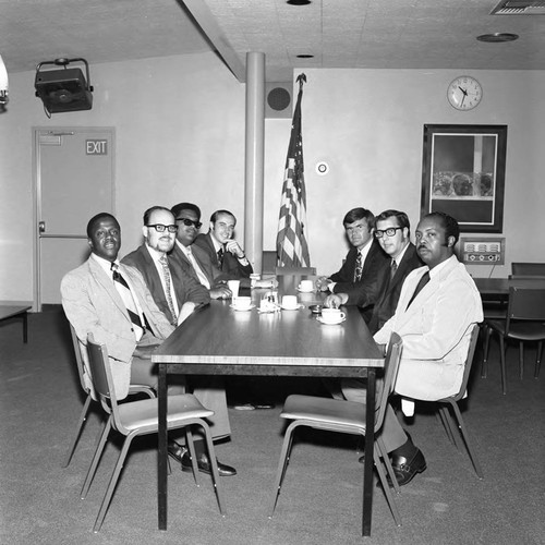 Men posing together in a Compton College meeting room, Compton, 1972