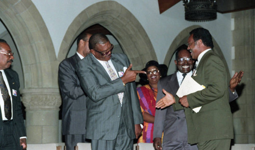 Rev. Jesse Jackson greeting an unidentifed man at the Tournament of Roses protest rally, Pasadena, 1993