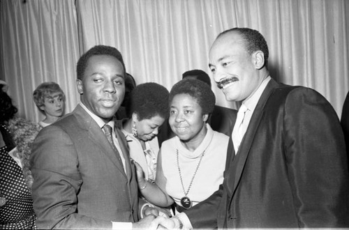 Group talking during a mayoral campaign event for Tom Bradley, Los Angeles, 1969