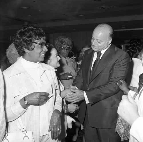 Joseph Alioto greeting a woman during a special event, Los Angeles, 1973