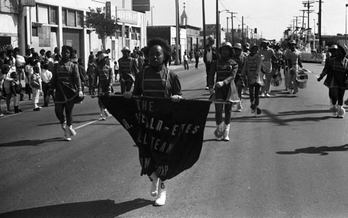 Los Angeles Emeraldettes Drill Team performing during the South Central Los Angeles Easter Parade, Los Angeles, 1983