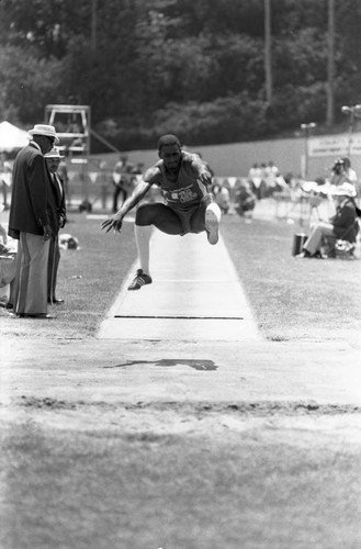 Athlete completing a long jump, Los Angeles, 1982