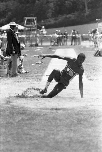 Carl Lewis completing a long jump, Los Angeles, 1982