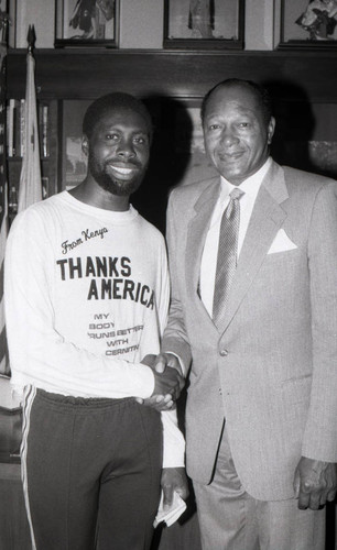 Tom Bradley posing with a man from Kenya, Los Angeles, 1985