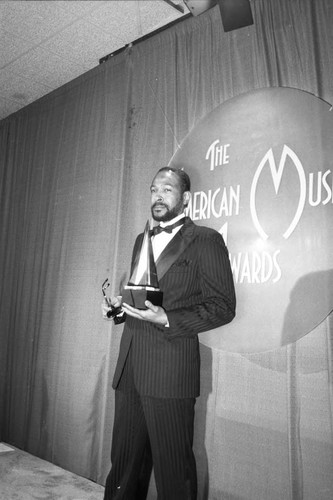 Marvin Gaye posing with his award at the American Music Awards, Los Angeles, 1983