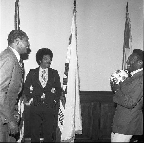 Pelé holding a soccer ball while talking with Mayor Bradley, Los Angeles, 1975