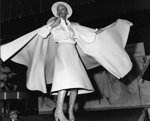 Ebony Fashion Fair model posing on a runway