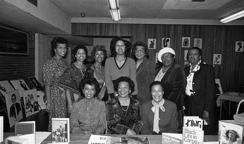 African American women posing together at a book display, Los Angeles, 1983