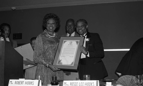 Rev. Cecil L. Murray receiving a commendation from Diane Watson during the First AME Church mortgage retirement party, Los Angeles, 1986