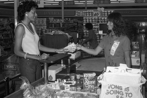 Black Dollar Days customer purchasing food at Von's Market, Los Angeles, 1983