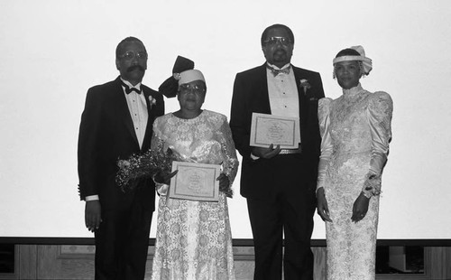 Bishop Wayne S. Davis and his wife standing with others at the First Apostolic Church inaugural banquet, Los Angeles, 1987