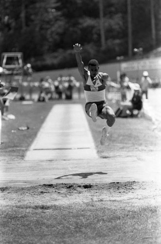 Athlete completing a long jump, Los Angeles, 1982