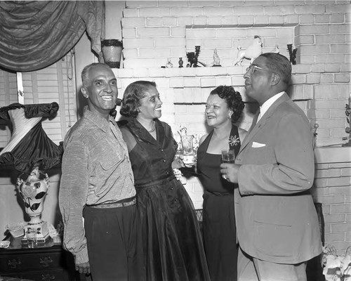 African American couples talking at a party, Los Angeles