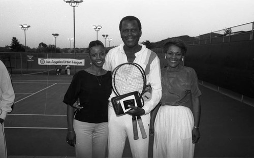 Sidney Poitier posing with others at an Urban League event, Los Angeles, 1985